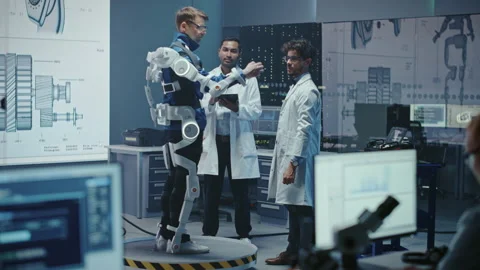 Technology and Development Laboratory Engineers Testing Exoskelet on Person Stock Footage 136595546