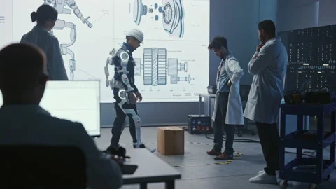 Technology and Development Laboratory Engineers Testing Exoskelet on Person Stock Footage 136595723
