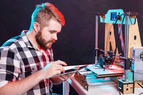 Technology and engineering concept - Male engineer working at night in the lab Stock Photos