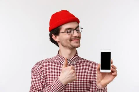 Technology and people concept. Close-up portrait pleased happy young hipster man Stock Photos
