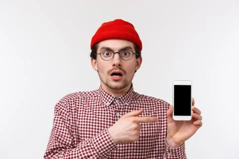 Technology and people concept. Close-up portrait impressed young man showing Stock Photos