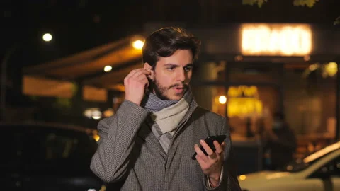 Technology, app -man chooses the song to listen on the phone and dances - night  Stock-Footage 147354951