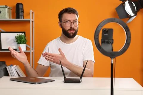 Technology blogger explaining something while recording video at home Stock Photos