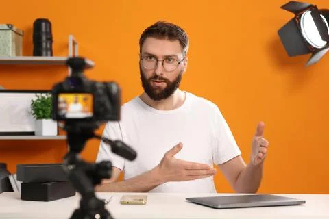 Technology blogger explaining something while recording video at home Stock Photos
