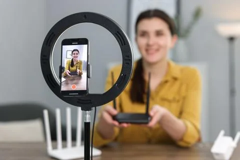Technology blogger explaining something while recording video at home, focu.. Stock Photos