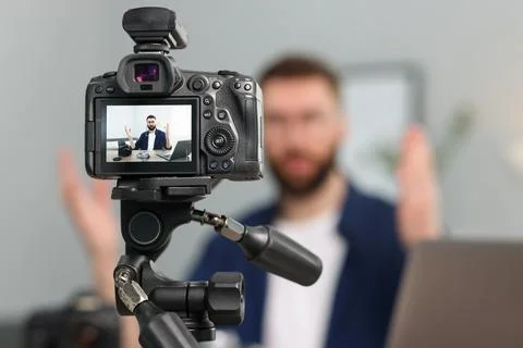Technology blogger explaining something while recording video at home, focu.. Stock Photos
