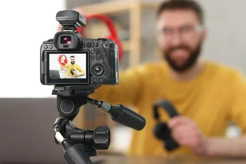 Technology blogger explaining something while recording video at home, focu.. Stock Photos