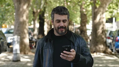 Technology, communication-young man reads a message on his phone and smiling  Stock Footage 141701298