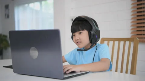 Technology concept of 4k Resolution. Asian boy playing computer games in the  Stock Footage 166639238