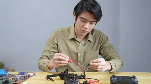 Technology concept of 4k Resolution. Asian man fixing drone in room. check fo Stock Footage 196949511