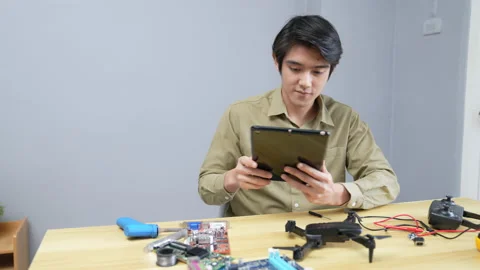 Technology concept of 4k Resolution. Asian man fixing drone in room. check fo Stock Footage 198585935