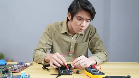 Technology concept of 4k Resolution. Asian man fixing drone in room. check .. Stock Footage 229786026