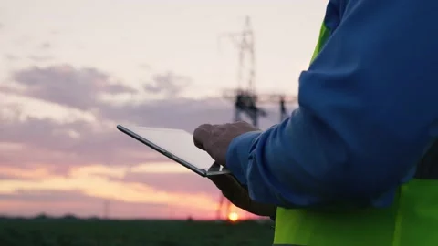 Technology concept with high voltage power lines. electrical engineer helmet Stock Footage 171321742