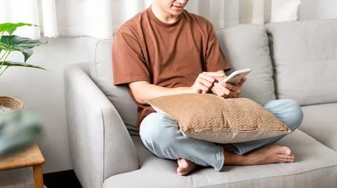 Technology Concept The man sitting next to a pot of plant, putting a small pi Stock Photos