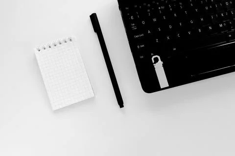 Technology concept of notepad and pen, laptop and flash drive Stock Photos