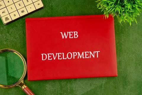 Technology concept. Words WEB DEVELOPMENT on the cover of a red notebook on a Stock Photos