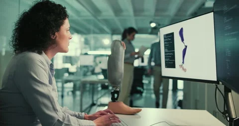 Technology, development and woman at computer screen with prosthetic leg, coding Stock Footage 283588479