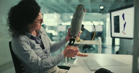 Technology, development and woman at computer with prosthetic leg, thinking and Stock Footage 283663160