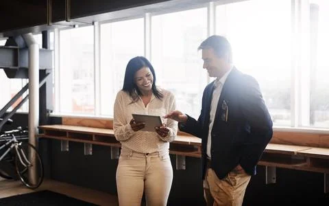 Technology does most of the task for them. two businesspeople working together Stock Photos