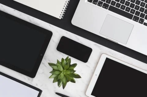 Technology flat lay. Workplace with office tools and gadget laptop, digital Stock Photos