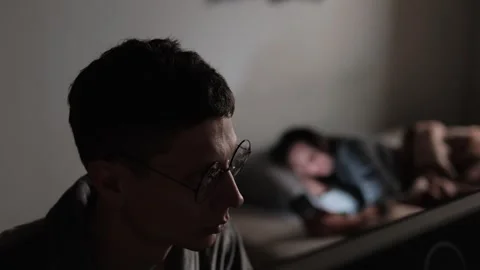 Technology Gap Between Partners. Man Working, Woman on Phone. Living Together Stock Footage 306655173