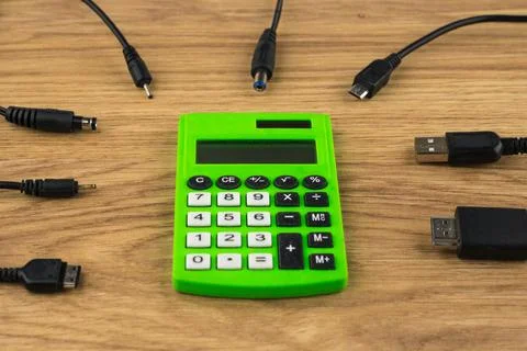 Technology generation gap: old dusty calculator and lots of plugs that can't  Stock Photos