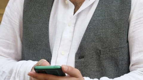 Technology, globalization - young focused man types on the mobile phone keyboard Stock Footage 220507839