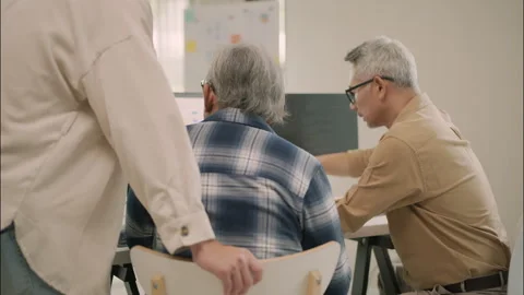 Technology Guidance And Collaboration Between Senior And Young Team. Stock Footage 308163765