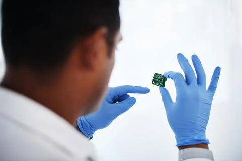 Technology, hardware and man in lab with microchip for motherboard maintenance Stock Photos