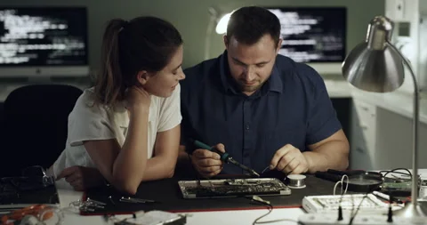 Technology, hardware and repair team in office with motherboard, tools and Stock Footage 300294499