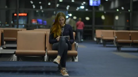 Technology of helping waste time lady with tablet at airport Stock Footage 157260723