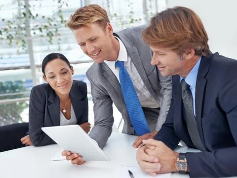 Technology helps them to be more efficient. A young businessman showing his Stock Photos