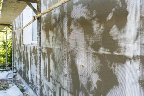 Technology of insulation walls by foamed, layer of foam, mesh, glue Fotos Stock