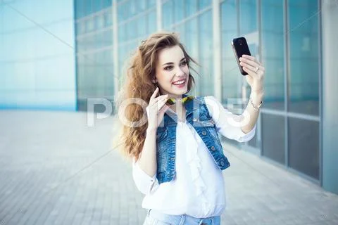 Technology internet and happy people concept - beautiful girl taking picture Stock Photos