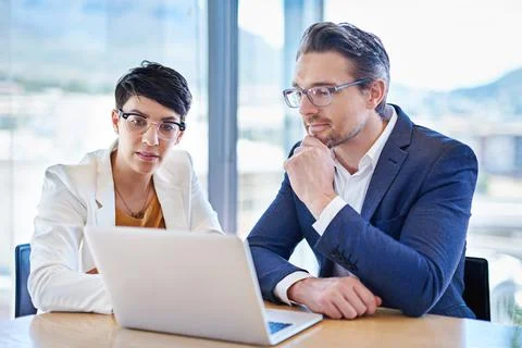 Technology keeps them close to competitor activity in business. two colleagues Stock Photos