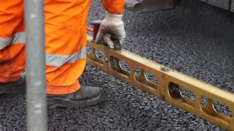 Technology for laying bitumen mixture, road repair Stock Footage 276969136