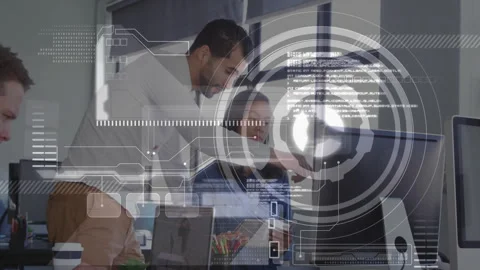 Technology lead leaning over developer laptop pointing at screen and guiding Stock Footage 309721555