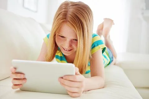Technology makes for hands on learning. a little girl using a digital tablet at Stock Photos