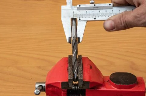 The technology of measuring the diameter of the drill, using calipers Stock Photos