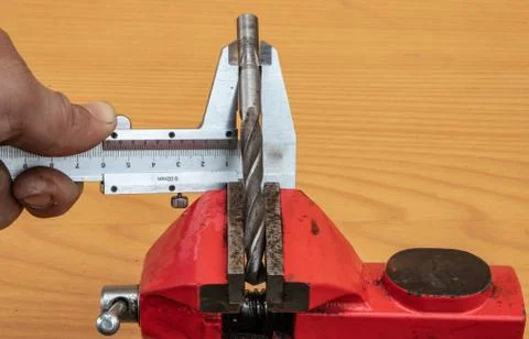 The technology of measuring the diameter of the drill, using calipers Stock Photos