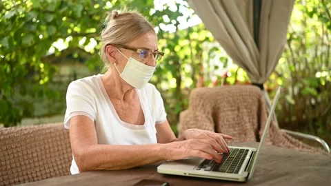 Technology, old age people concept - elderly senior woman takes off protective Stock Footage 142288173