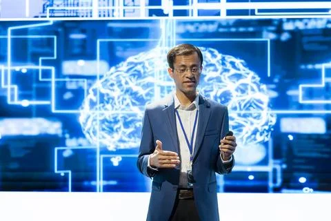 Technology presenter uses headset mic to talk about AI research Stock Photos