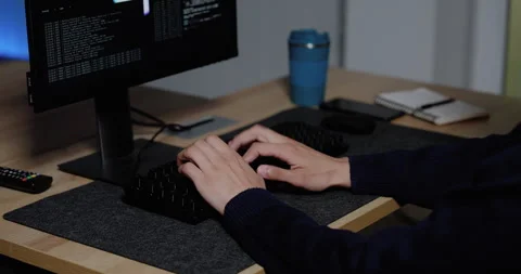 Technology professional typing source code on keyboard while multiple monitors Stock Footage 343733048