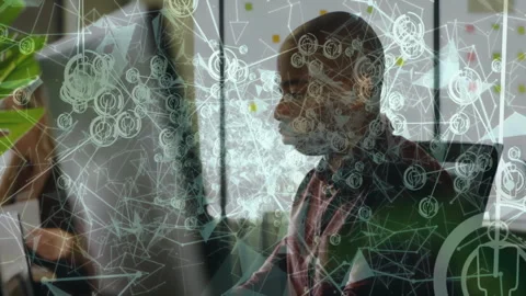 Technology professionals working on computers with animated network overlay Stock Footage 308658486