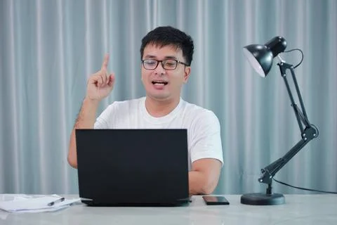 Technology, remote job and lifestyle concept - happy asian man  man in glasse Stock Photos