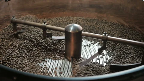 Technology roasting coffee beans at the factory. Mixing just fried coffee grains Stock Footage 96039091