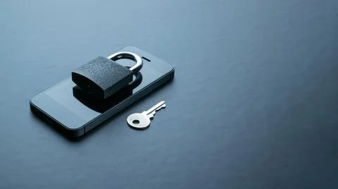 Technology security. Modern space grey mobile phone with padlock, key on dark Stock Photos