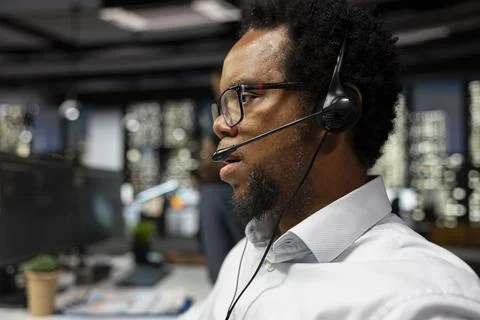 Technology startup helpdesk technician speaking in headset mic Stock Photos