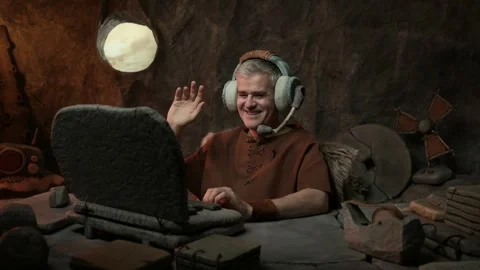 Technology in the stone age: businessman having a video call Stock Footage 333046521