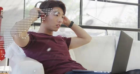 Technology student coding on couch and activating animated code overlay while Stock Footage 318688817